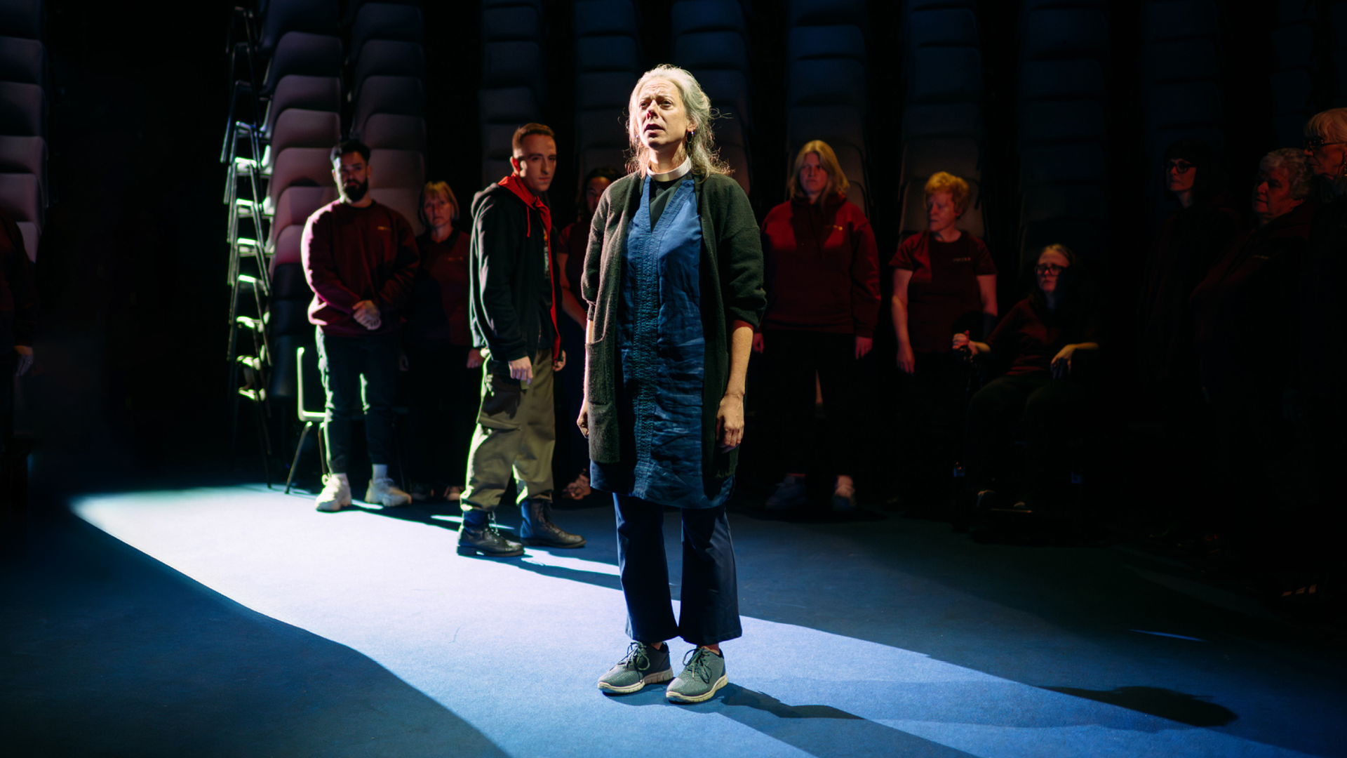 Professional actors in theatre show with community choir